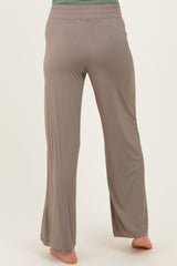 woman wearing light brown maternity lounge pants, seen from the back