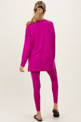woman wearing a bright pink long sleeve maternity top and matching leggings, showing a comfortable and stylish outfit