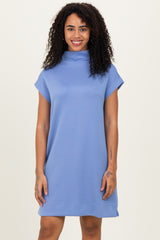 woman wearing a light blue short sleeve cowl neck dress with a relaxed fit