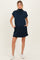 woman wearing a navy blue maternity dress with short sleeves and pockets