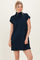 woman wearing a navy blue short sleeve mock neck dress with a relaxed fit