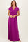 woman wearing a purple short sleeve maxi dress with a wrapped bodice and flowy skirt