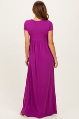 woman wearing a solid purple short sleeve maxi dress from the back, featuring a fitted bodice and flowy skirt