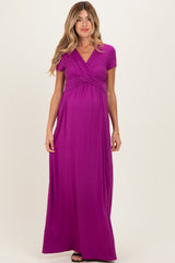 woman wearing a vibrant purple short sleeve maternity maxi dress with a gathered waist and baby bump visible