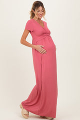 woman wearing a dusty rose maternity maxi dress with a wrap-style bodice and baby bump visible
