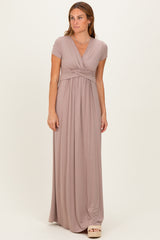 woman wearing a dusty rose short sleeve maxi dress with a wrap design and gathered waistline