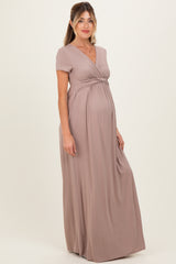 woman wearing a taupe short sleeve maternity maxi dress showcasing her baby bump