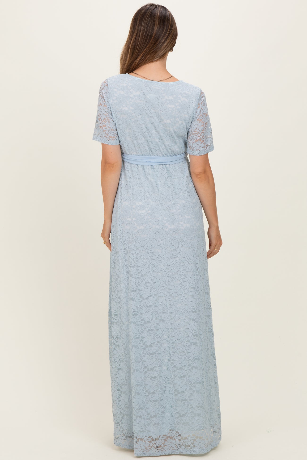 maternity wear light blue lace maxi dress with short sleeves and a fitted waist, shown from the back