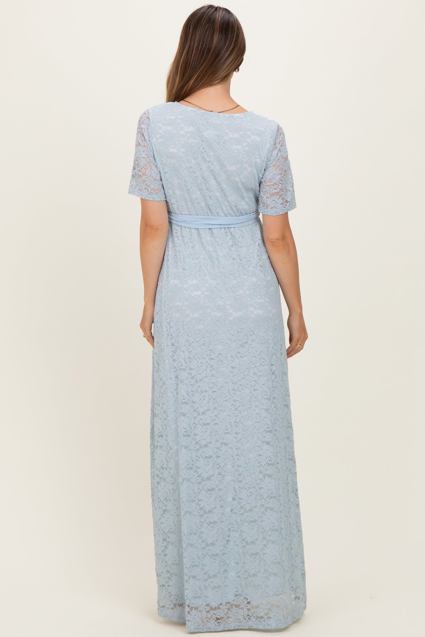 maternity wear light blue lace maxi dress with short sleeves and a fitted waist, shown from the back