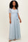 woman wearing a light blue lace maxi dress with short sleeves and a tied waist detail