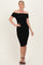woman wearing a black off-the-shoulder ruched bodycon dress with a fitted silhouette and strappy heels