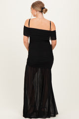 woman wearing a black off-the-shoulder maternity gown with ruched detailing and sheer bottom panels