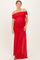 woman wearing a red off-the-shoulder maternity gown with ruching and a flowing skirt, showcasing her baby bump