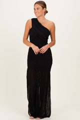 woman wearing a black one-shoulder ruched maxi dress with a sheer skirt detail