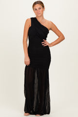 woman wearing a black one-shoulder evening gown with ruched detailing and a sheer skirt