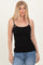 woman wearing a black fitted camisole top with thin straps and blue high-waisted jeans
