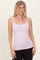 woman wearing a light pink fitted camisole tank top with thin straps and styled with black leggings
