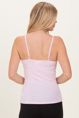 woman wearing a light pink spaghetti strap tank top, viewed from the back