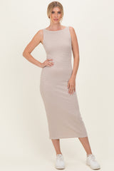 woman wearing a striped beige and white midi dress with a fitted silhouette and simple neckline