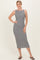 woman wearing a black and white striped midi dress with a fitted silhouette and boat neckline