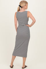 woman wearing a black and white striped sleeveless midi dress, showing a back view