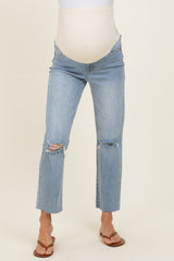 woman wearing distressed light blue maternity jeans with a supportive belly panel