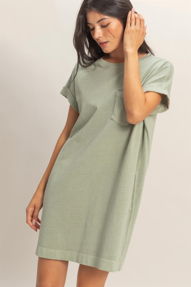 woman wearing a light green oversized t-shirt dress with short sleeves and a chest pocket