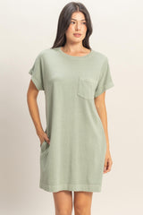woman wearing a relaxed fit green short sleeve t-shirt dress with a chest pocket