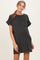 woman wearing a black short sleeve maternity dress with a front pocket and a relaxed fit, showing her baby bump