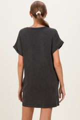 woman wearing a dark gray oversized maternity dress with rolled sleeves