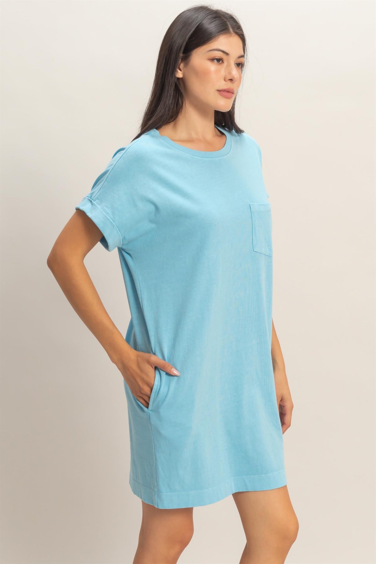 woman wearing a light blue short sleeve dress with a pocket and side seams
