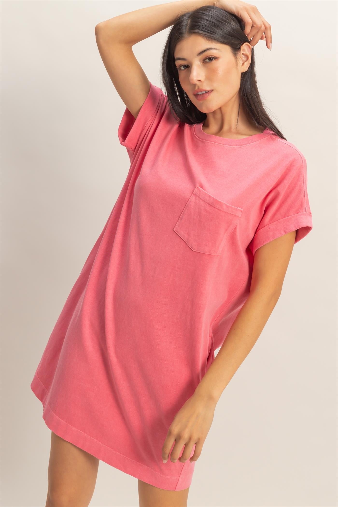 woman wearing a pink oversized t-shirt dress with a chest pocket and rolled sleeves
