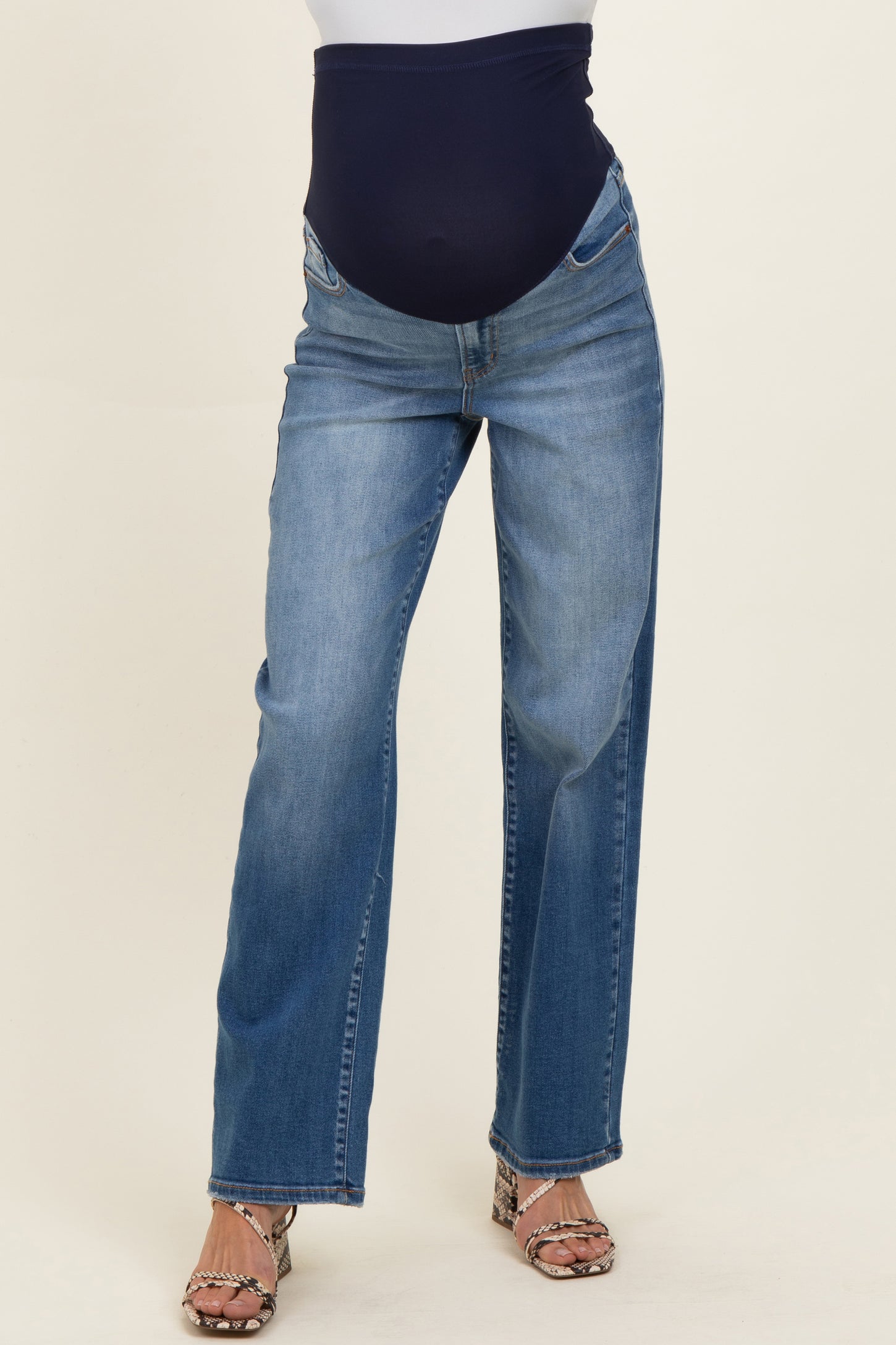 woman wearing a pair of blue maternity jeans with a supportive over-the-bump waistband