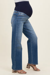 woman wearing a pair of blue straight-leg maternity jeans with a supportive waistband and a visible baby bump