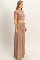 woman wearing a taupe cropped top and matching high-waisted wide-leg pants