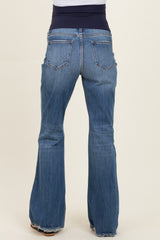 maternity wear flared blue jeans with a dark blue elastic waistband, worn by a model from the back
