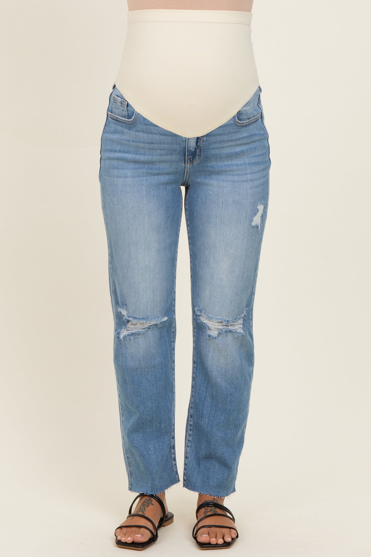 maternity wear light blue distressed jeans with a high waistband, model showing a baby bump