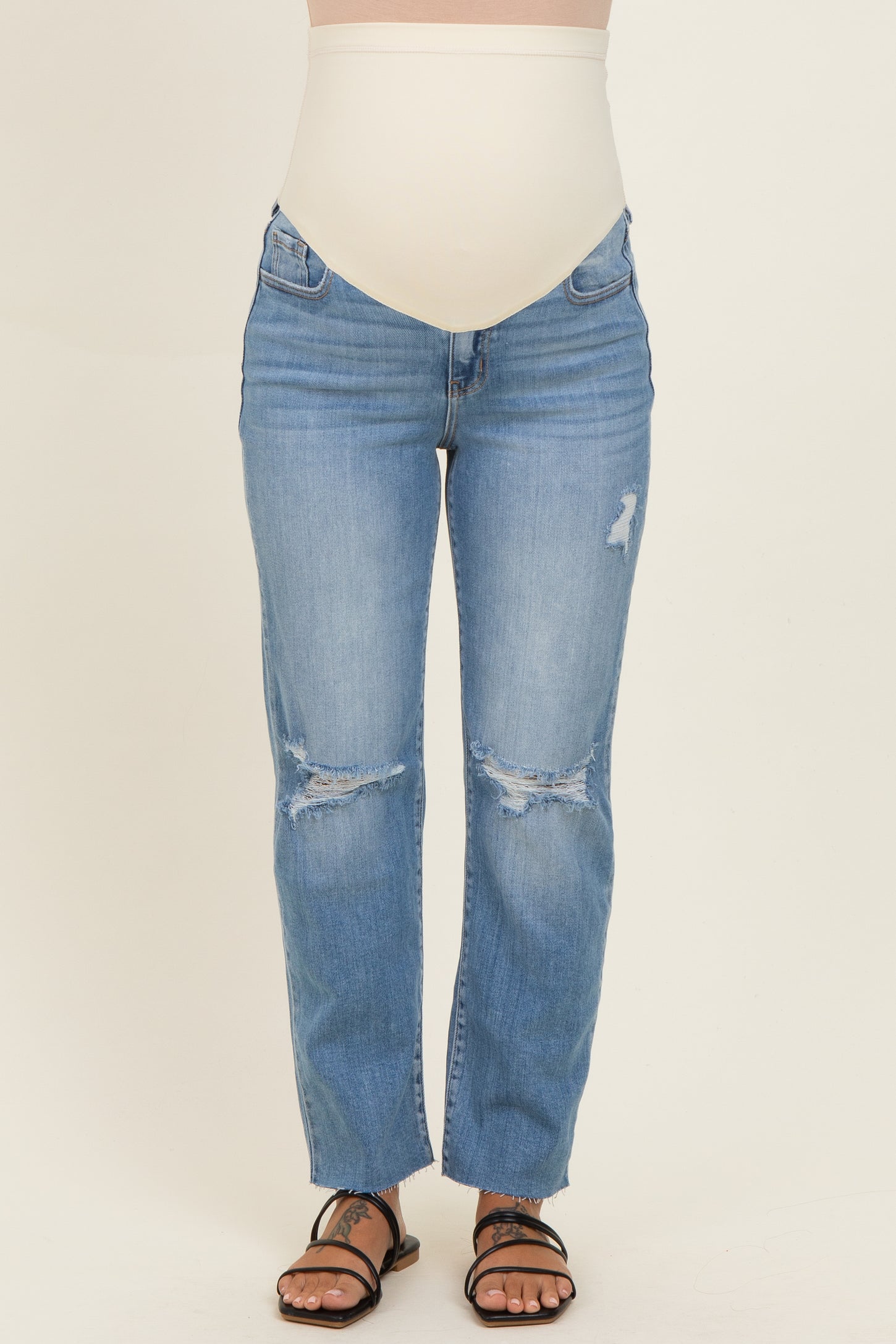 maternity wear light blue distressed jeans with a high waistband, model showing a baby bump
