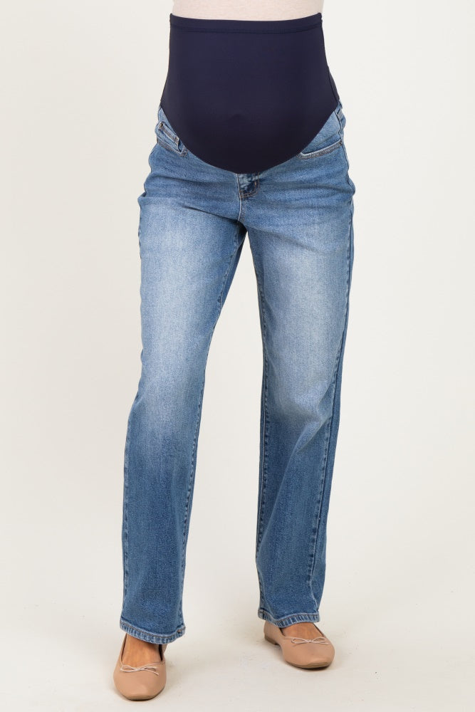 woman wearing a pair of light blue maternity jeans with a navy over-the-bump panel and a straight leg cut