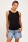 woman wearing a black ribbed maternity tank top and denim shorts, with a visible baby bump