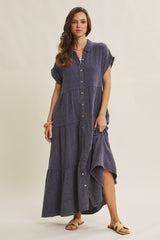 woman wearing a navy blue button-up maxi dress with short sleeves and tiered detailing