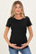 woman wearing a black short sleeve maternity top and holding her baby bump