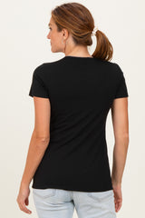 woman wearing a black short sleeve fitted top, seen from the back