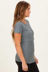 woman wearing a gray ribbed short sleeve top with a relaxed fit and layered design