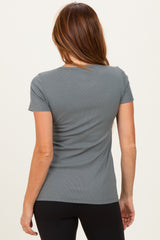woman wearing a gray ribbed short sleeve top, view from the back, paired with black leggings