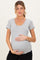 woman wearing a gray short sleeve maternity top and holding her baby bump