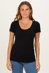 woman wearing a black short sleeve scoop neck top with a fitted style and a natural look