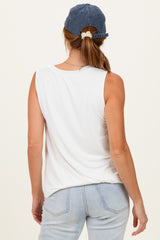 woman wearing a white sleeveless top with a relaxed fit and blue cap, showing the back view