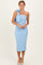 woman wearing a light blue one-shoulder midi dress with a bow detail and a fitted silhouette