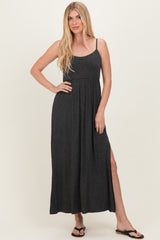 woman wearing a black and gray striped maxi dress with a side slit and spaghetti straps